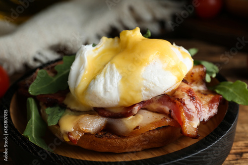 Tableau sur toile Delicious egg Benedict served on wooden table, closeup