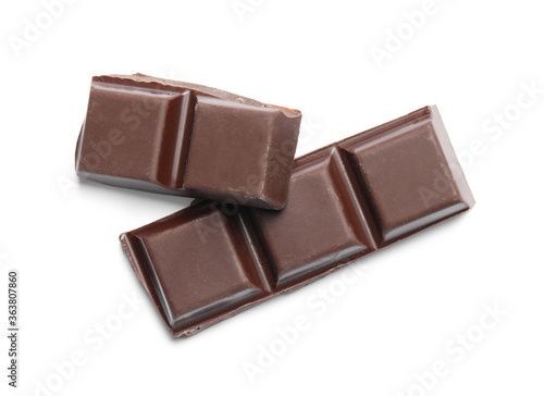 Pieces of delicious dark chocolate isolated on white, top view