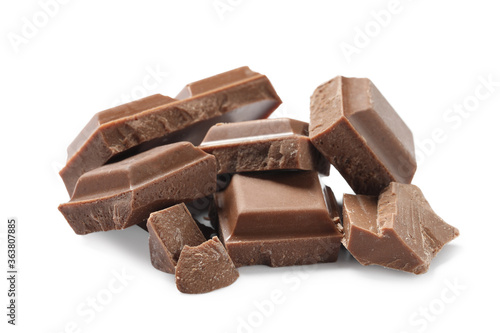 Pieces of delicious milk chocolate isolated on white