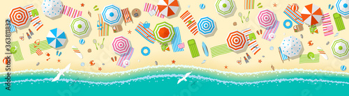 Vector illustration. Panorama of a sunny beach. Top view. Summertime - sea, sand, umbrellas, towels, chairs, clothes, objects. (view from above)