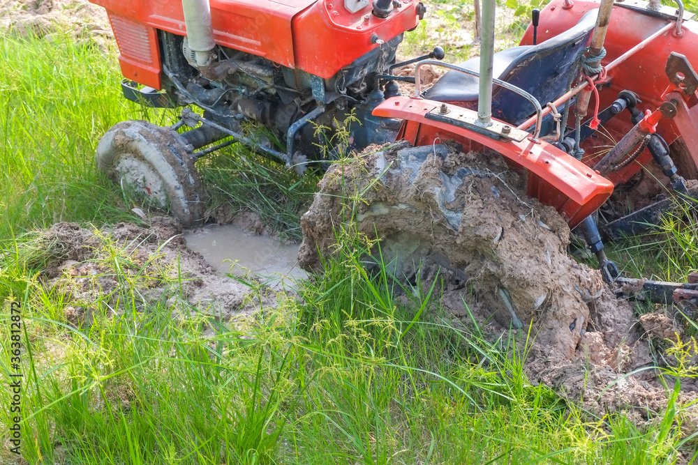 Wheel of old tractor plowing the soil for planting stuck the mud in agricultural fields. foto de