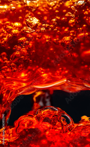 Splashes in glass on a dark background, macro shot.