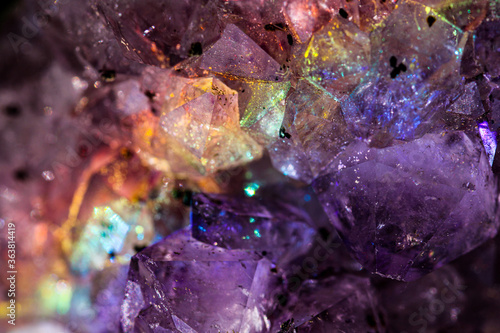 Iridescent natural transparent glossy and magic geometric Quartz crystal stucture through sun light.