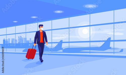 Lonely business man traveler wearing face mask with luggage walking at empty airport gate terminal lounge traveling during pandemic outbreak. Airplanes behind glass window with city skyline sunset.