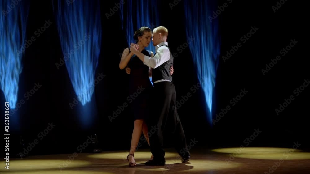 A man and a woman dancing tango. Beautiful light, professional dancers. A man and a woman dancing tango. Beautiful light, professional dancers.