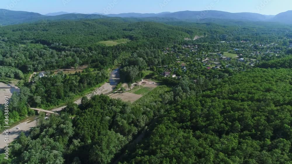 Aerial view: green forest, hills, valley, farm and village. Rural landscape Aerial view: green forest, hills, valley, farm and village. Rural landscape