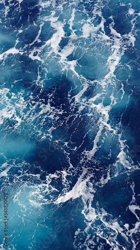 Background of the sea surface, foam stains on clean fresh ocean water. Vertical photo aerial view © Artem