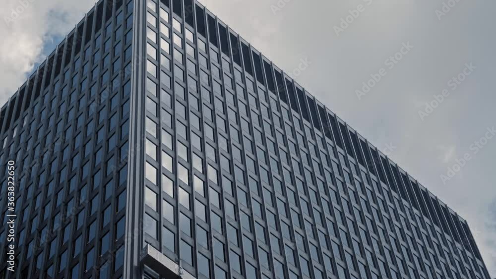 Downtown urban office building with scaffolding reflecting cinematic clouds in summer timelapse Downtown urban office building with scaffolding reflecting cinematic clouds in summer timelapse