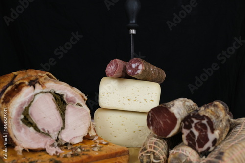 Tavolo con salumi e norcineria. Salame, prosciutto, porchetta, formaggio, lonza, lonzino, galantina photo