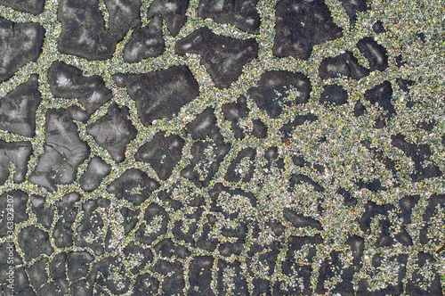 Cracked waterproofing and pebbles on cracks