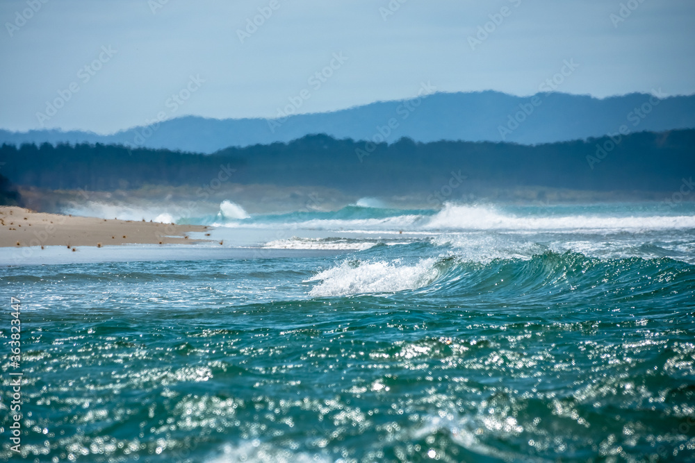 Pacific Ocean waves breaking on the beach. New Zealand