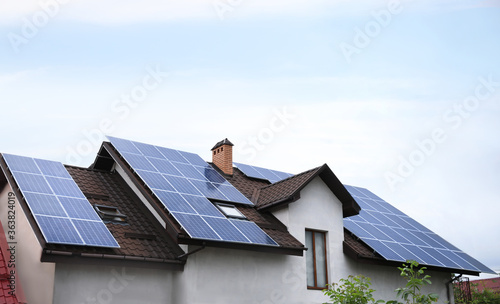 House with installed solar panels on roof. Alternative energy source