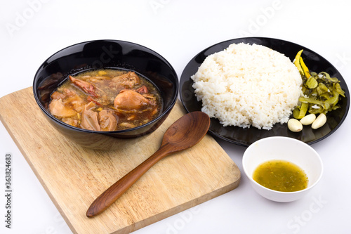 Stewed pork leg with pickled mustard greens and rice on white background