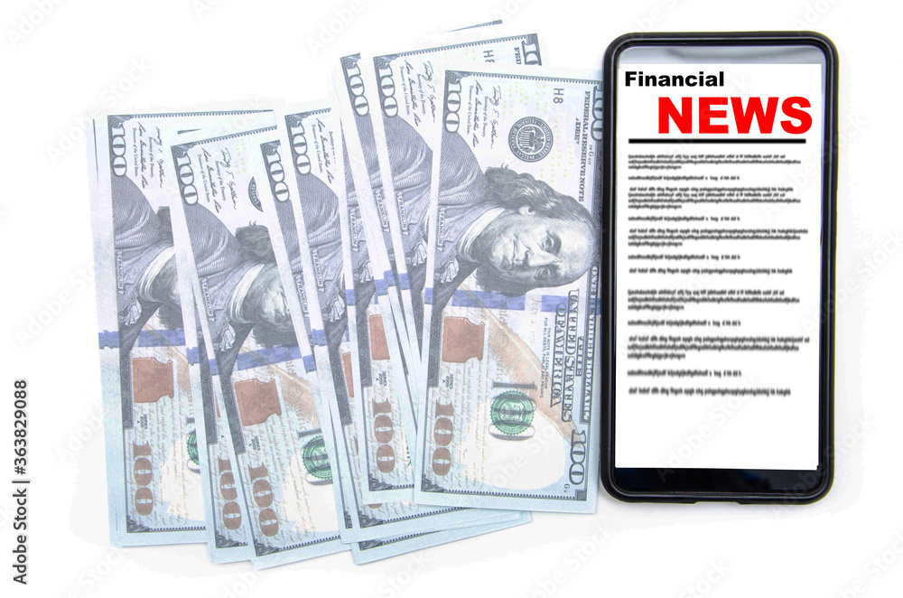 Fototapeta premium The smartphone on the screen the inscription financial news lies on dollars. 100 dollars banknotes and smartphone with financial news.
