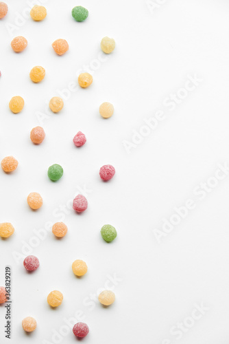 Close up of colorful fruit caramel, hard sugar candies or boiled sweets isolated on white background. 