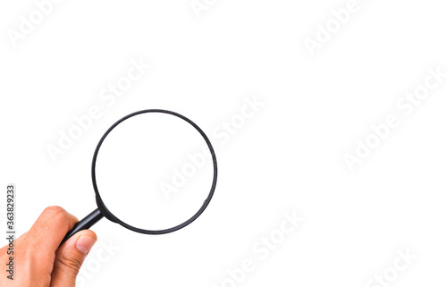Male hand holds a magnifying glass on a white background