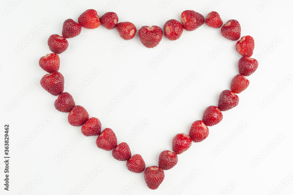 heart is laid out of strawberries on a white background heart is laid out of strawberries on a white background