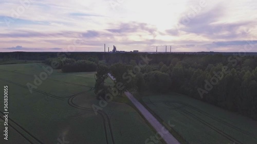 Factory Chimneys Beyond The Forest Horizon 4K Aerial Track Left Pedestal-Up Shot photo