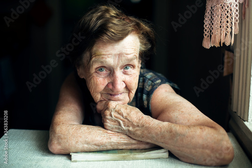 A very old woman, a portrait in her house.