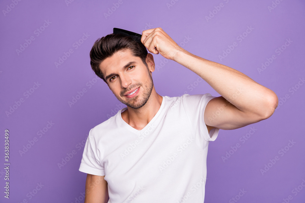 Close-up portrait of his he nice attractive well-groomed content cheery brown-haired guy combing hair enjoying process isolated on bright vivid shine vibrant lilac violet purple color background Close-up portrait of his he nice attractive well-groomed content cheery brown-haired guy combing hair enjoying process isolated on bright vivid shine vibrant lilac violet purple color background