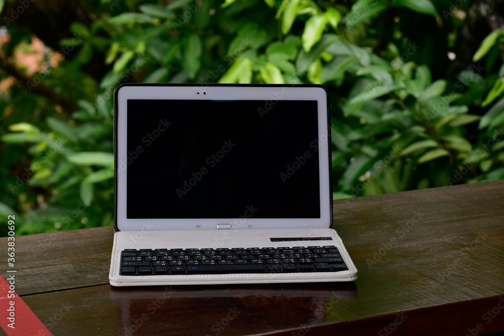 A laptop placed on the table On a natural background
A laptop placed on the table On a natural background