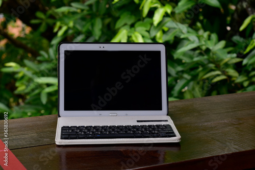 
A laptop placed on the table On a natural background