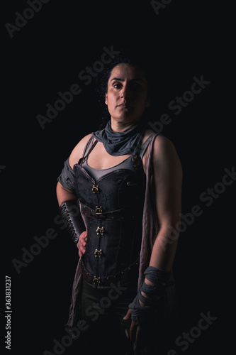 medieval woman shooting in dark studio