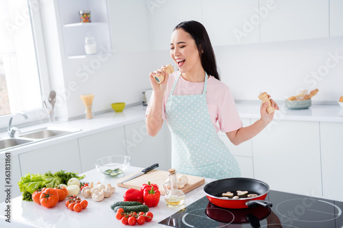 Portrait of her she nice attractive cheerful cheery girl making domestic meal lunch cuisine singing having fun hobby enjoying healthy life in modern light white interior kitchen indoors