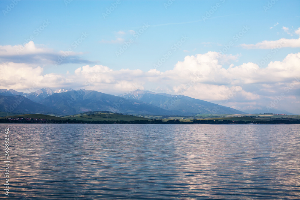 View of a beautiful lake with snowy Tatras in the background
