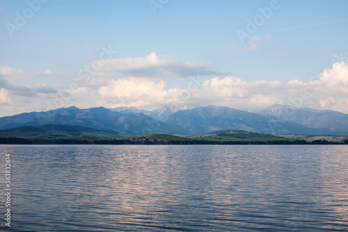 View of a beautiful lake with snowy Tatras in the background