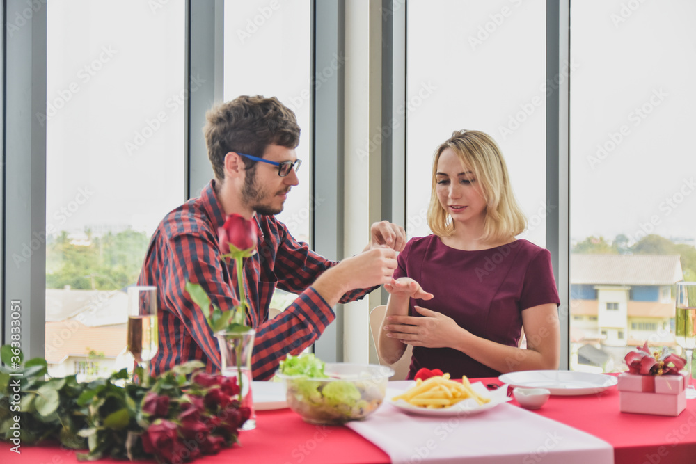 Lovers wear wedding rings for each other in the restaurant,Couple love