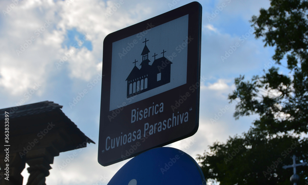 DESESTI, MARAMURES, ROMANIA, SUMMER 2018. Indicative sign of the beautiful wooden orthodox church of San Parascheva or Desesti.