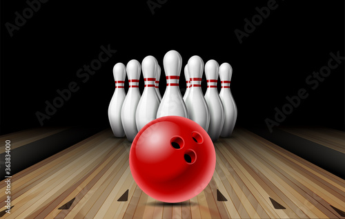 Red glossy ball rolling on bowling alley line to ten placed in order white bowling pins.