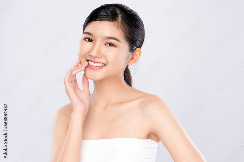 Beauty face. Smiling asian woman touching healthy skin portrait. Beautiful happy girl model with fresh glowing hydrated facial skin and natural makeup on white background, Beauty face. Smiling asian woman touching healthy skin portrait. Beautiful happy girl model with fresh glowing hydrated facial skin and natural makeup on white background,