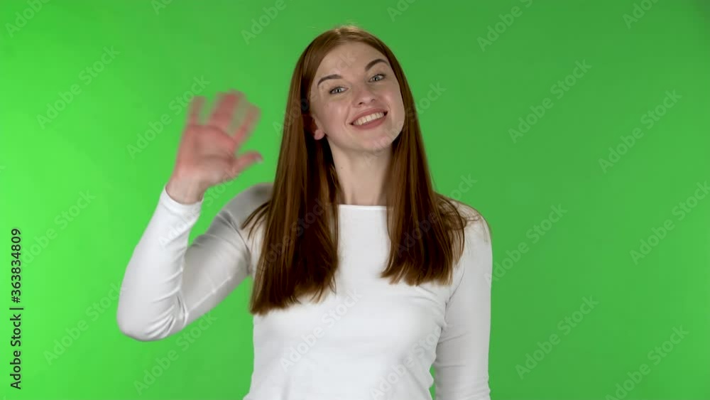 Portrait of pretty young woman is waving hand and showing gesture come here. Portrait of pretty young woman is waving hand and showing gesture come here.