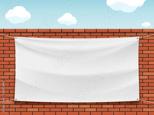 White blank banner on a street red brick wall.