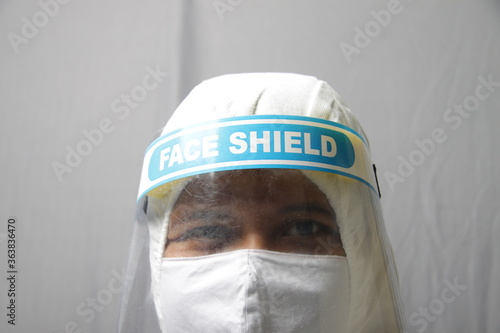 Man using protection suit, face mask, and face shield for medical purpose to avoid invection photo