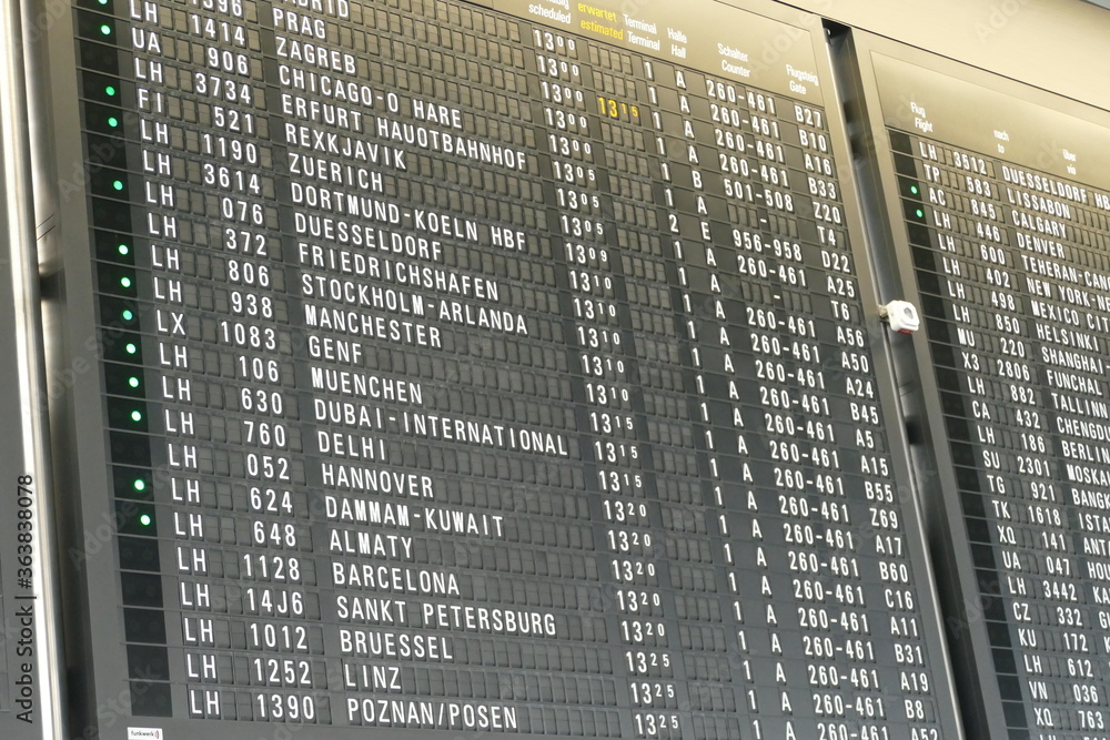 Fototapeta premium Black Airport Board with destinations in white letters.