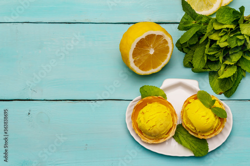 Lemon ice cream with mint. Refreshing summer dessert, ripe fruit, fragrant leaves
