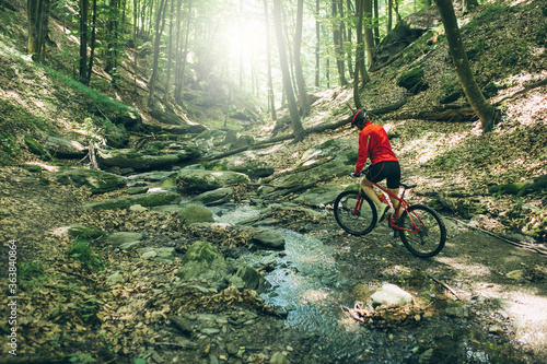 Mountain Bike cyclist woman riding bike at forest. Outdoor cyclist woman enjoying at nature.