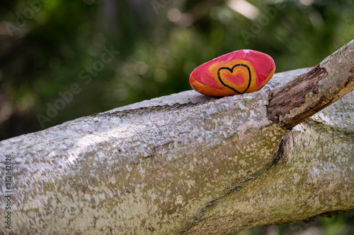 Colorful stone with a painted heart