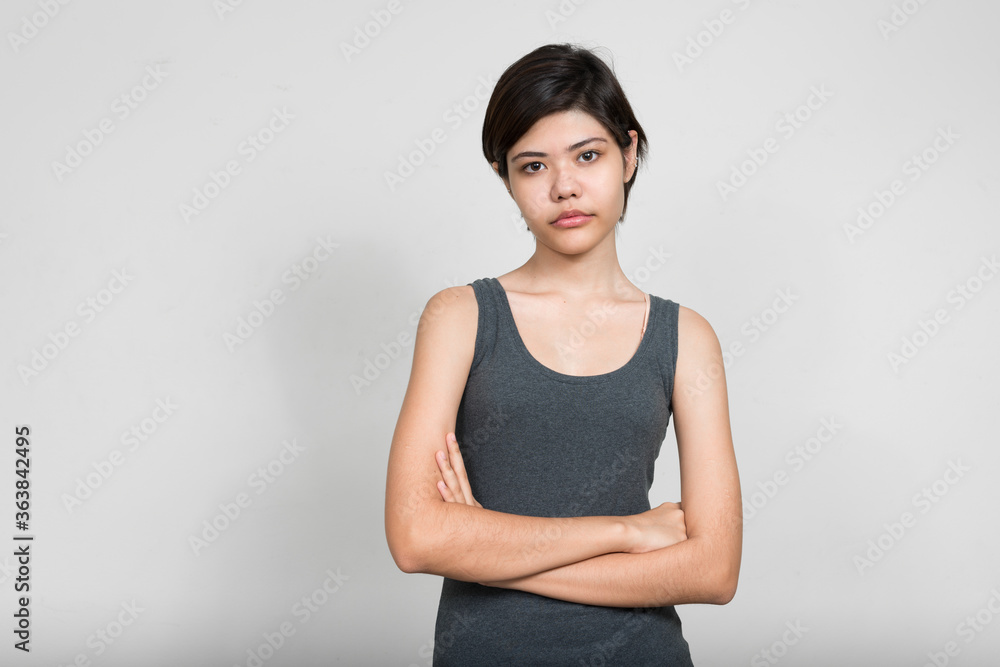 Portrait of young beautiful teenage girl with arms crossed Portrait of young beautiful teenage girl with arms crossed