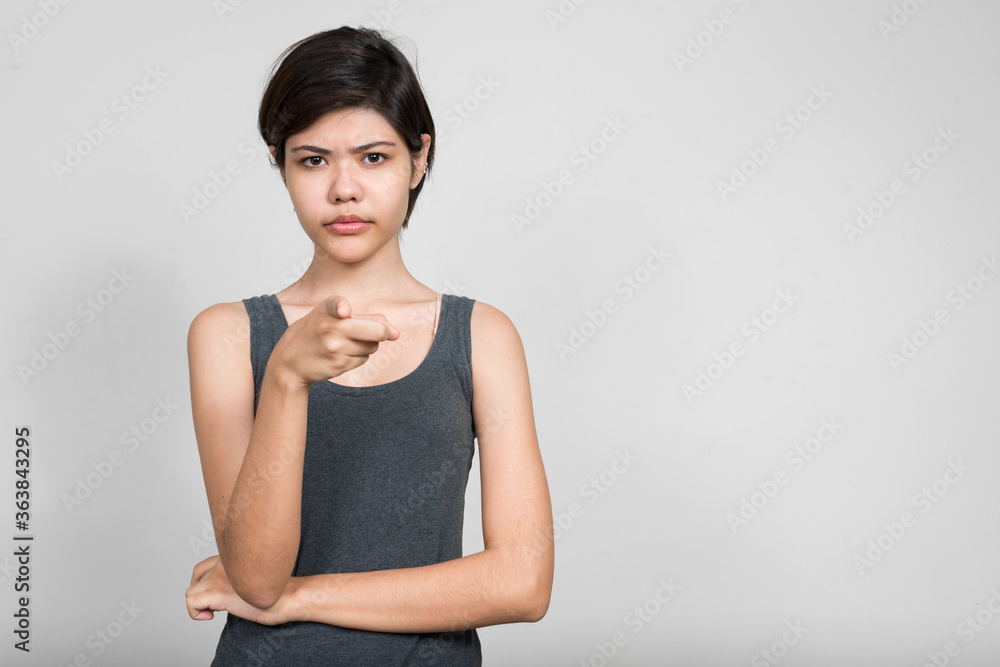 Portrait of stressed young teenage girl pointing at camera Portrait of stressed young teenage girl pointing at camera