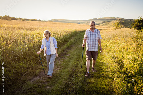 elderly couple trekking in a rural area social distancing