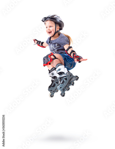 Five year old girl performs a roller skate trick
