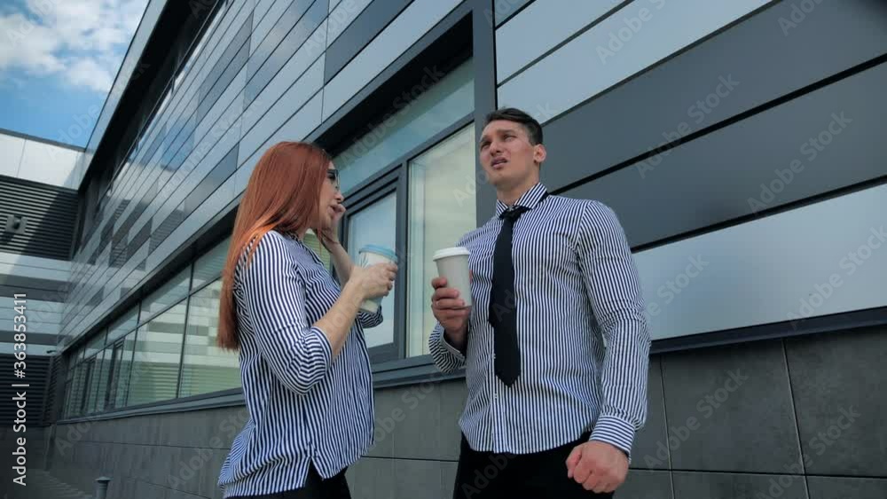 Two business people near the window business center drinking coffee at the end of the day and talk to hot gossip. Conference, friends. Two business people near the window business center drinking coffee at the end of the day and talk to hot gossip. Conference, friends.