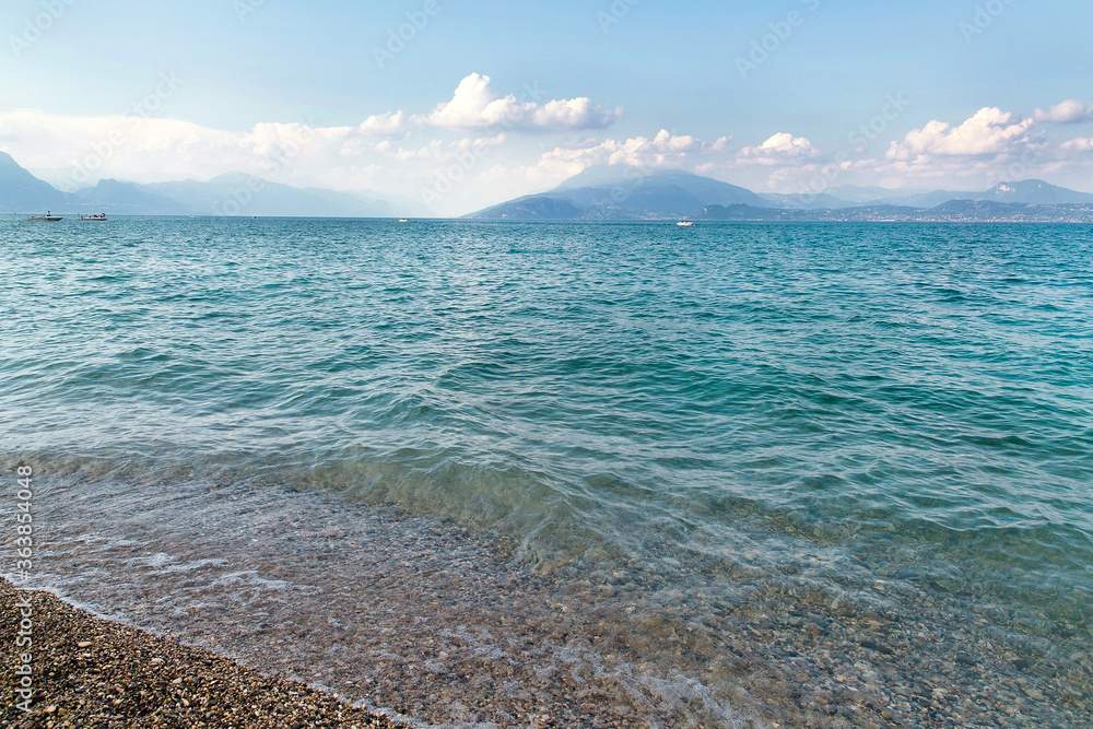 Magic scenery of italian lake Garda, Northen Italy in summmer. Blue water, mountains and fresh air. Holidays in Italy. 