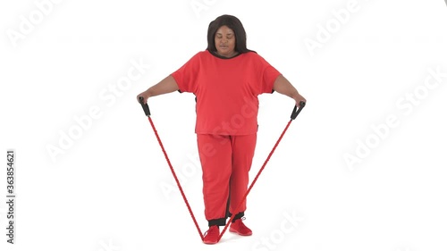 Portrait of african woman with overweight working out with expander isolated on white background photo