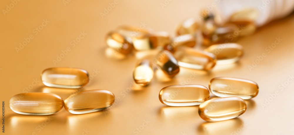 Many capsules Omega 3 on yellow background. Close up, high resolution product. Health care concept. Many capsules Omega 3 on yellow background. Close up, high resolution product. Health care concept.
