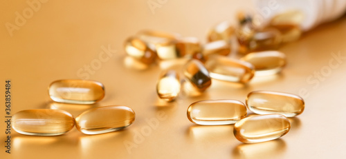 Many capsules Omega 3 on yellow background. Close up, high resolution product. Health care concept.